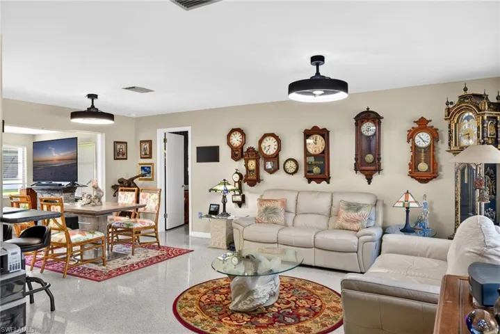 Living area featuring dark speckled floor and baseboards