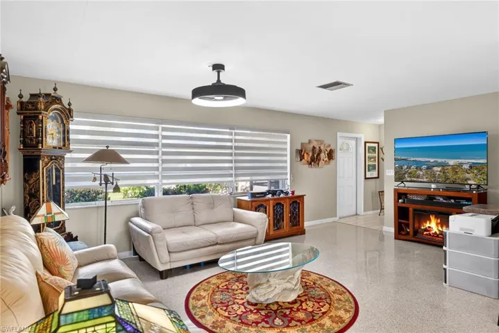 Living room featuring baseboards and dark speckled floor
