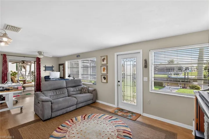 Living area with wood finished floors and a ceiling fan