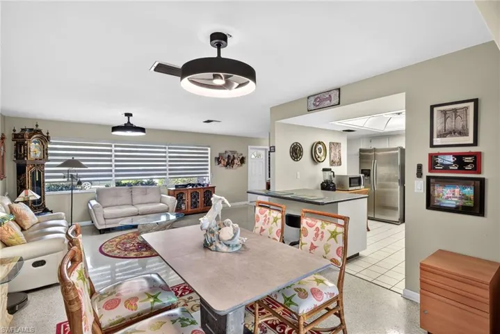 Dining area with ceiling fan and baseboards