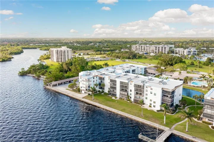 Birds eye view of property with a water view