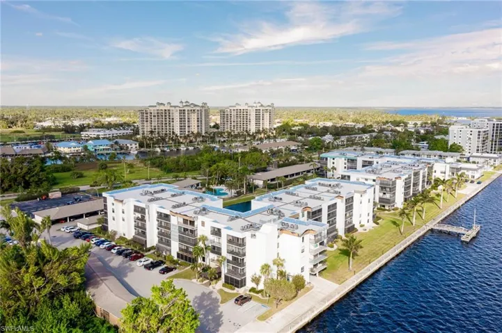 Birds eye view of property with a water view
