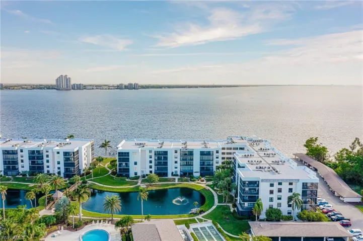 Birds eye view of property with a water view