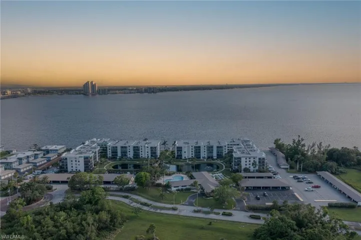 Aerial view at dusk featuring a water view