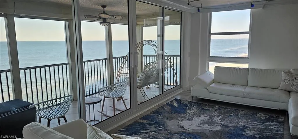 Sunroom / solarium with a water view and healthy amount of natural light