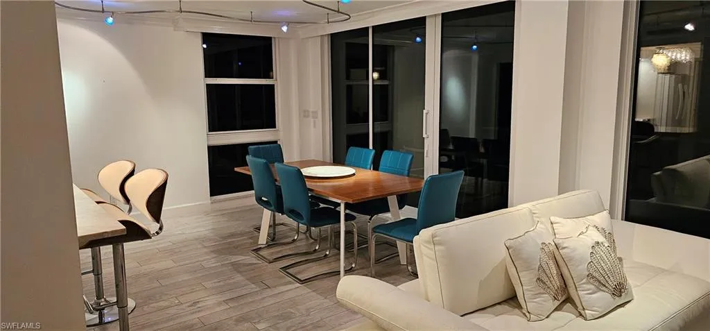 Dining space featuring light wood finished floors and track lighting