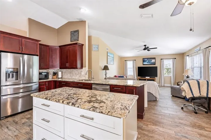 Open concept kitchen and living area with vaulted ceilings