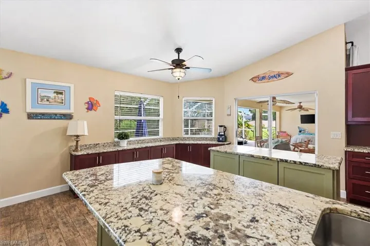 Vaulted ceilings, wood-finish flooring, two large windows, generous counter space, and built-in cabinetry