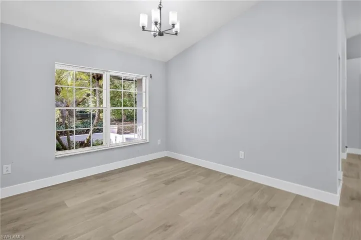Dining room featuring a chandelier, and vaulted ceiling.