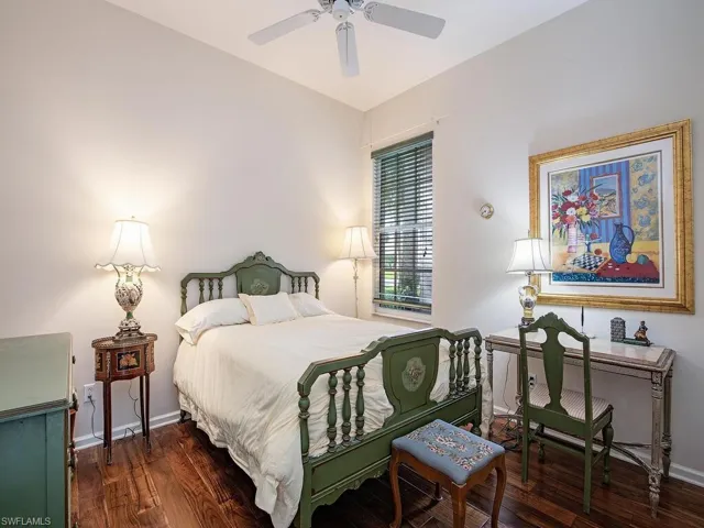 Guest bedroom with wood flooring
