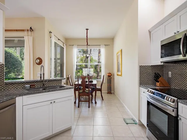 Kitchen updated with granite countertops, backsplash and newer appliances