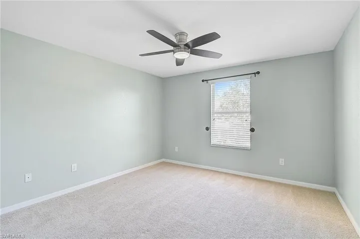 Empty room with carpet flooring and ceiling fan