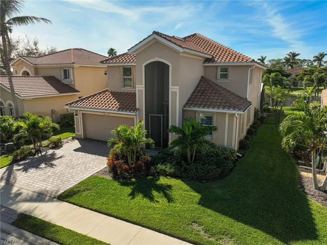 Mediterranean / spanish-style house with a front lawn and a garage