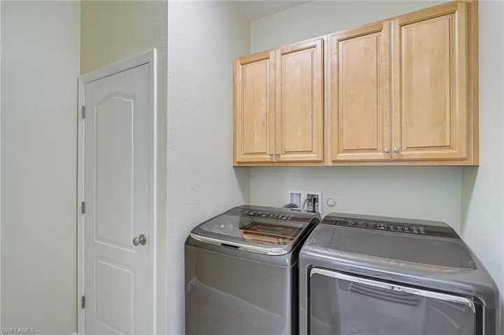 Laundry room with cabinets and separate washer and dryer