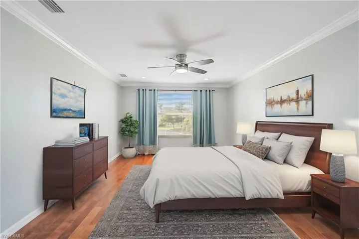 Bedroom with hardwood / wood-style floors, ceiling fan, and crown molding