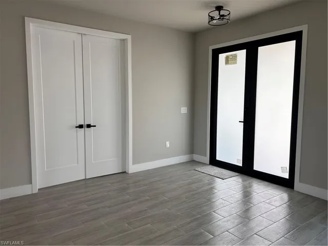 Unfurnished bedroom with a closet and french doors