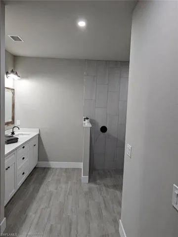 Bathroom with vanity and hardwood / wood-style floors