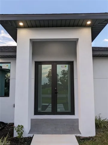 Property entrance featuring french doors