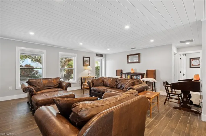Living room featuring wood ceiling and dark wood-type flooring