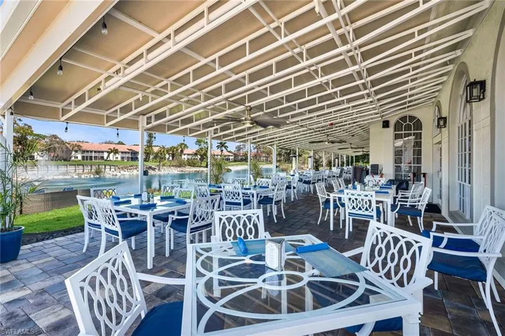 View of patio with outdoor dining space, a water view, and a residential view