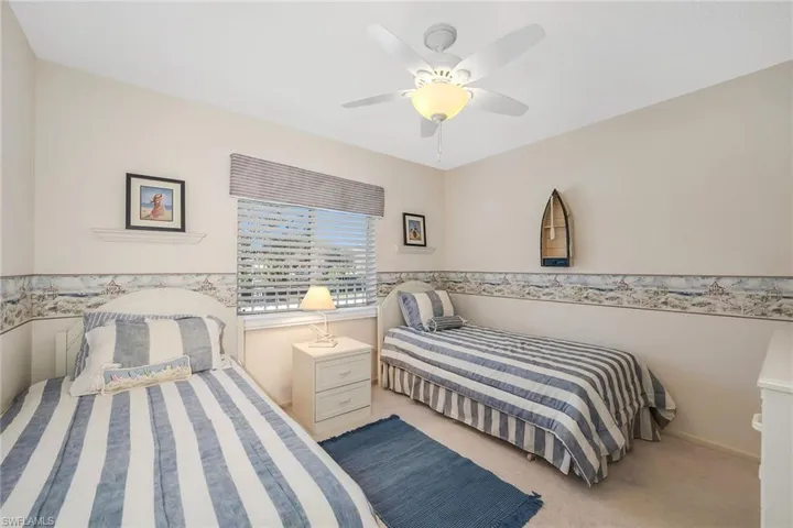 Bedroom featuring light carpet and a ceiling fan