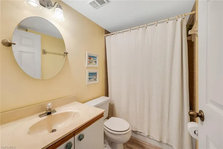 Full bath featuring vanity and shower / tub combo with curtain