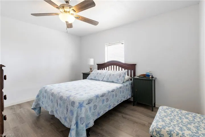 Bedroom with wood finished floors and a ceiling fan
