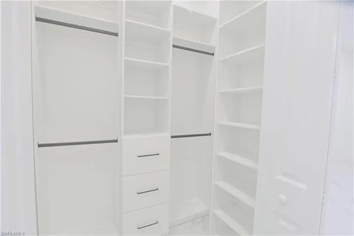 Spacious closet featuring marble look tiles