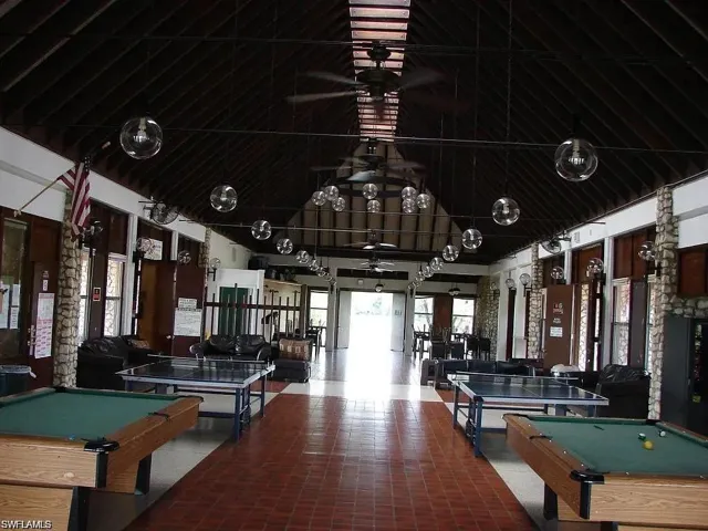 Game room featuring billiards, a ceiling fan, and a towering ceiling