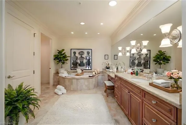 Full bathroom with vanity, a garden tub, crown molding, and recessed lighting