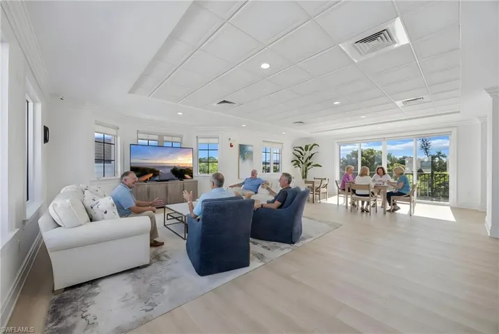 Living area with light wood-type flooring, recessed lighting, and ornamental molding