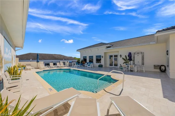 Community pool featuring a patio, french doors, and outdoor dining space