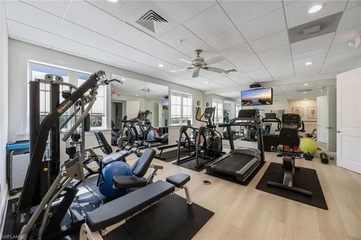 Gym featuring a paneled ceiling, a ceiling fan, and recessed lighting