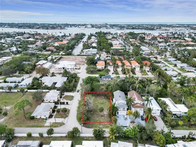 Birds eye view of property with a water view