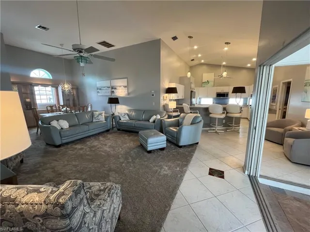 Open-concept interior featuring vaulted ceilings and recessed lighting