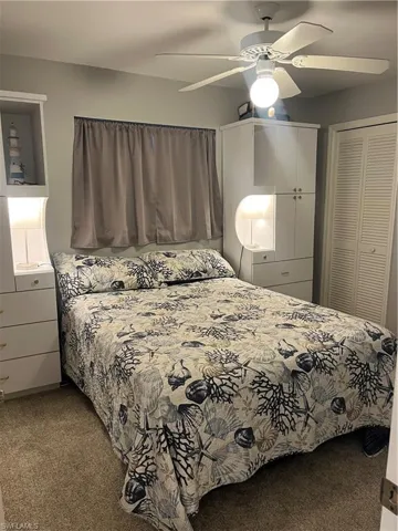 Built-in cabinetry flanking the bed with integrated shelving and lighting