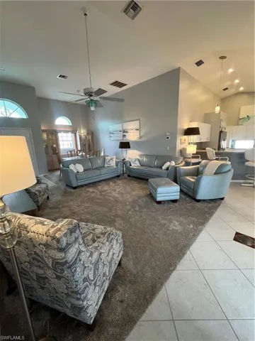 Vaulted ceilings with recessed lighting and a ceiling fan