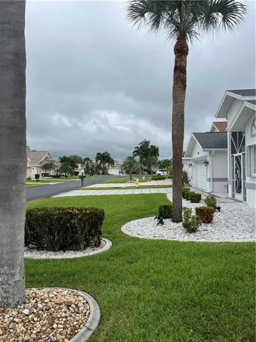 Manicured lawn with mature palm trees and decorative landscaping