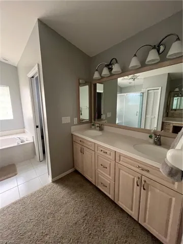 Double vanity with integrated sinks and a continuous countertop, complemented by dual mirror fixtures