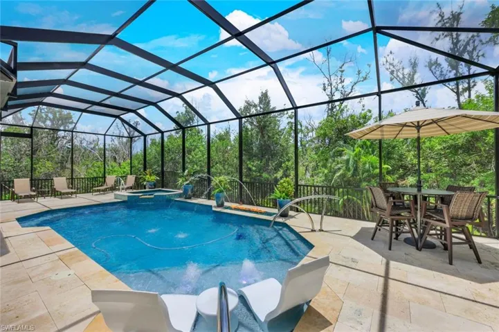 State of art saltwater pool with marble stone LED lighting, fire feature and water features  and an in ground glass surround spa that waterfalls into the pool.