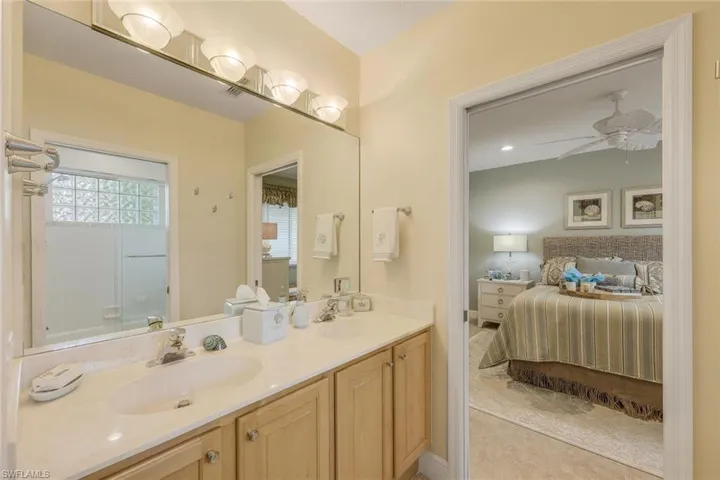 Jack and Jill bathroom featuring tile flooring, wood cabinetry, dual vanity