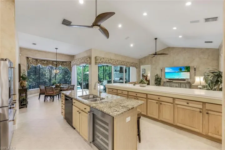 Kitchen with large island with dishwasher and  beverage cooler