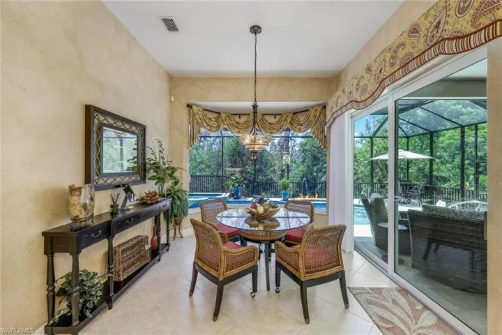 mitered glass windows surround your breakfast nook overlooking the pool and preserve.