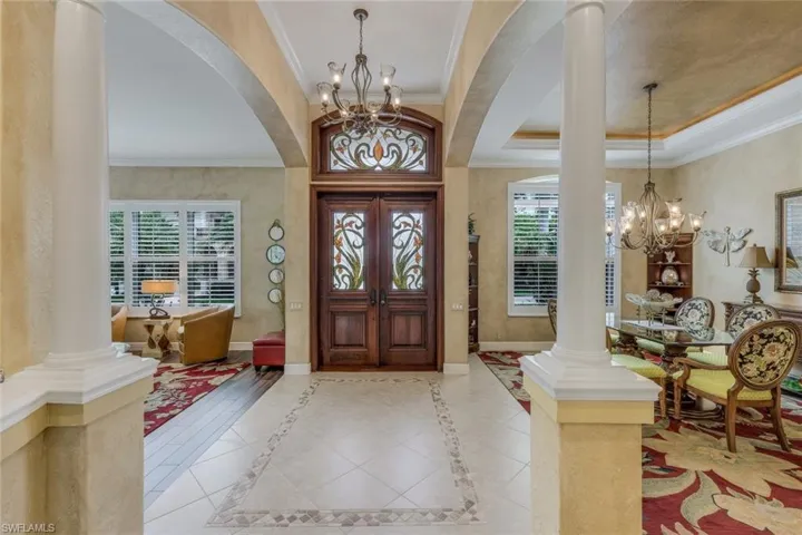 Stunning entry with glamorous custom glass inserts in this double entry with beefy wood door.