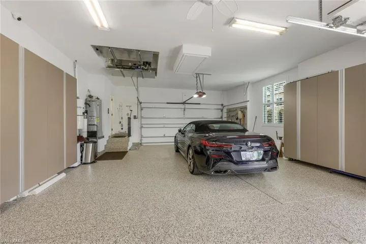 3 car spacious garage featuring  custom cabinetry pebble tech flooring