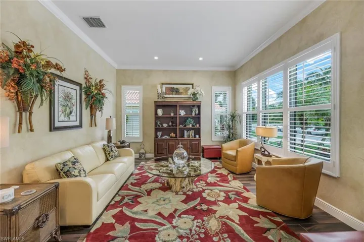 Comfy livingroom with crown molding lots of natural light just off the foyer.