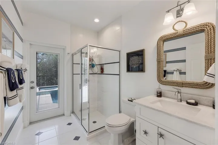 nautical guest/pool bath with oversized vanity and shower.