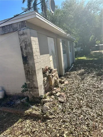 View of side of home featuring concrete block siding