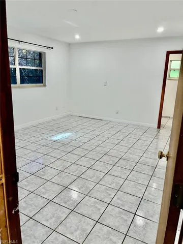 Spare room featuring healthy amount of natural light and light tile patterned floors