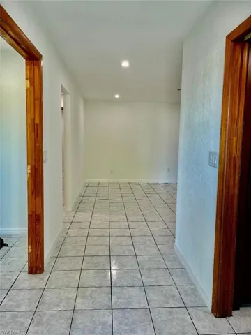 Hall featuring light tile patterned flooring and recessed lighting